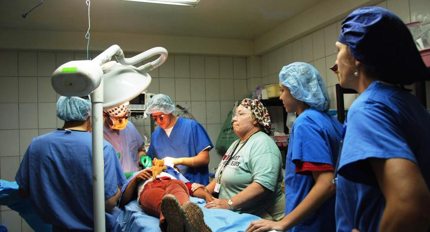 Dr. Weber, facial plastic surgeon, working with others on a patient