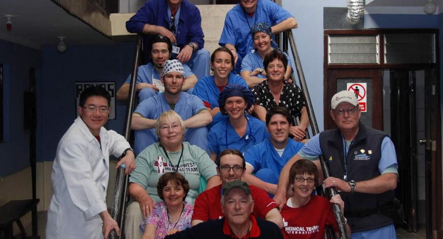 Dr. Weber and team sitting on stairs