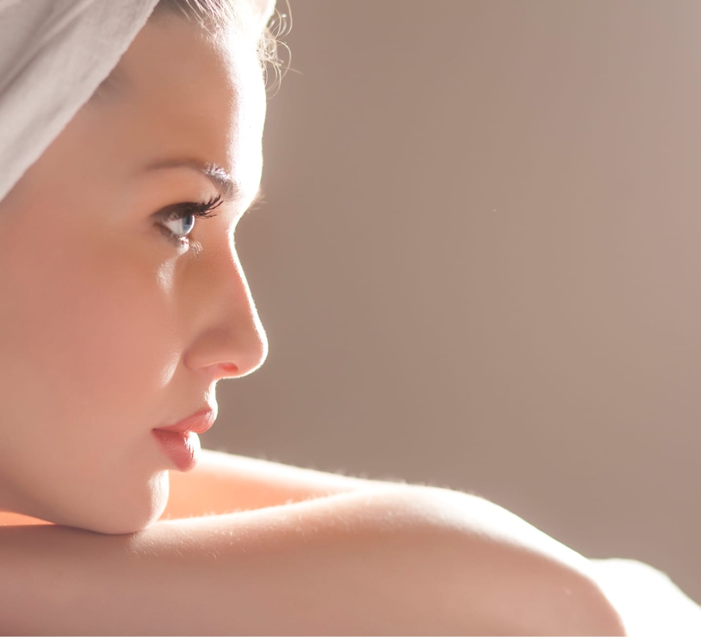 Picture of the side of a woman's face, her chin on her arm